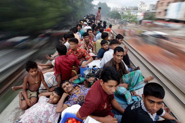 Passengers sit on top of an overcrowded train as it heads for Jamalpur from Dhaka.